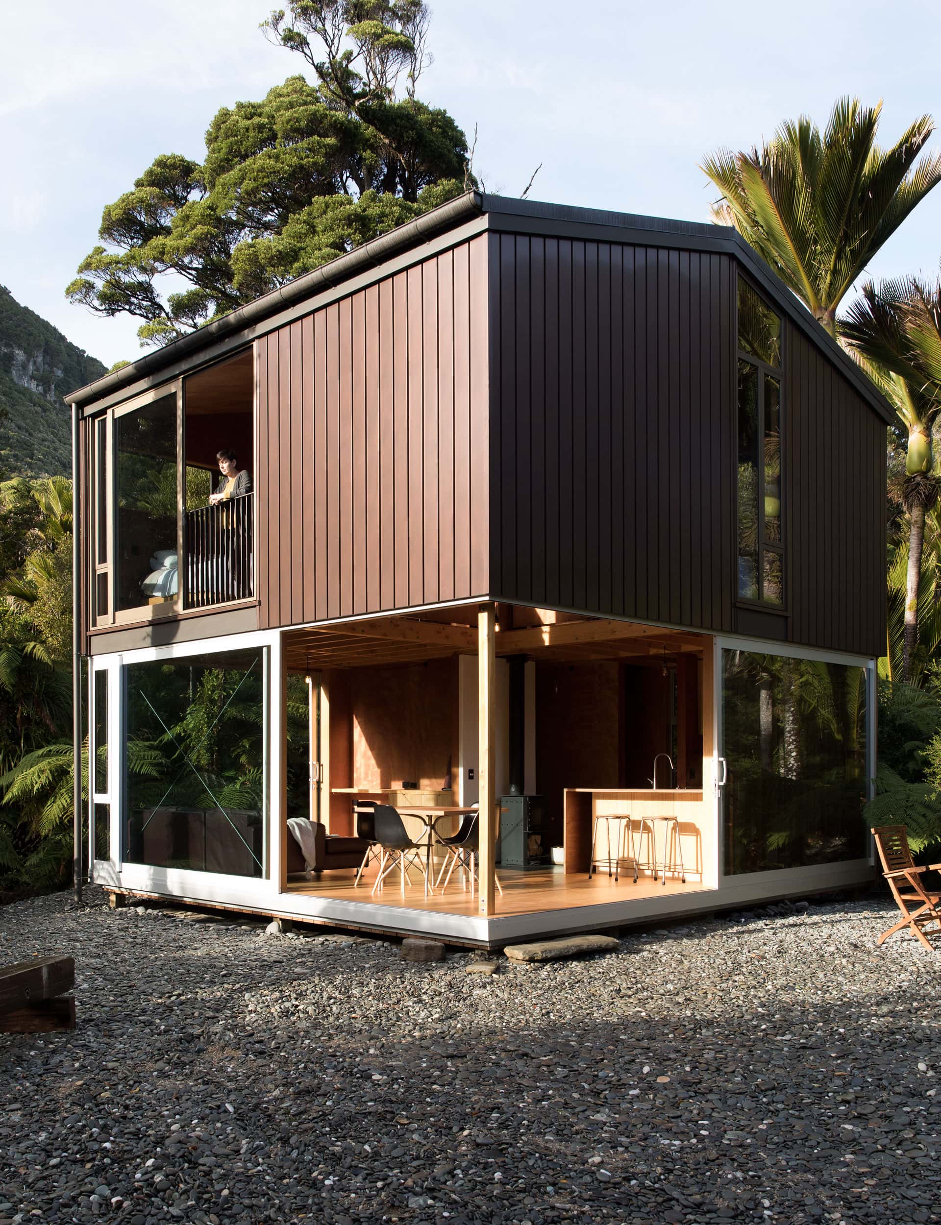 Nestled in a nikau glade this tiny home by Upoko Architects was designed to impose as little as possible on the site.  Image: David Straight 