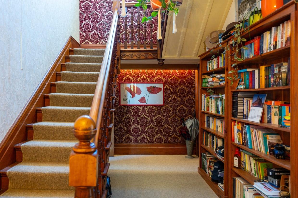 The handcarved timber stairs lead to the four bedrooms on the second storey. 