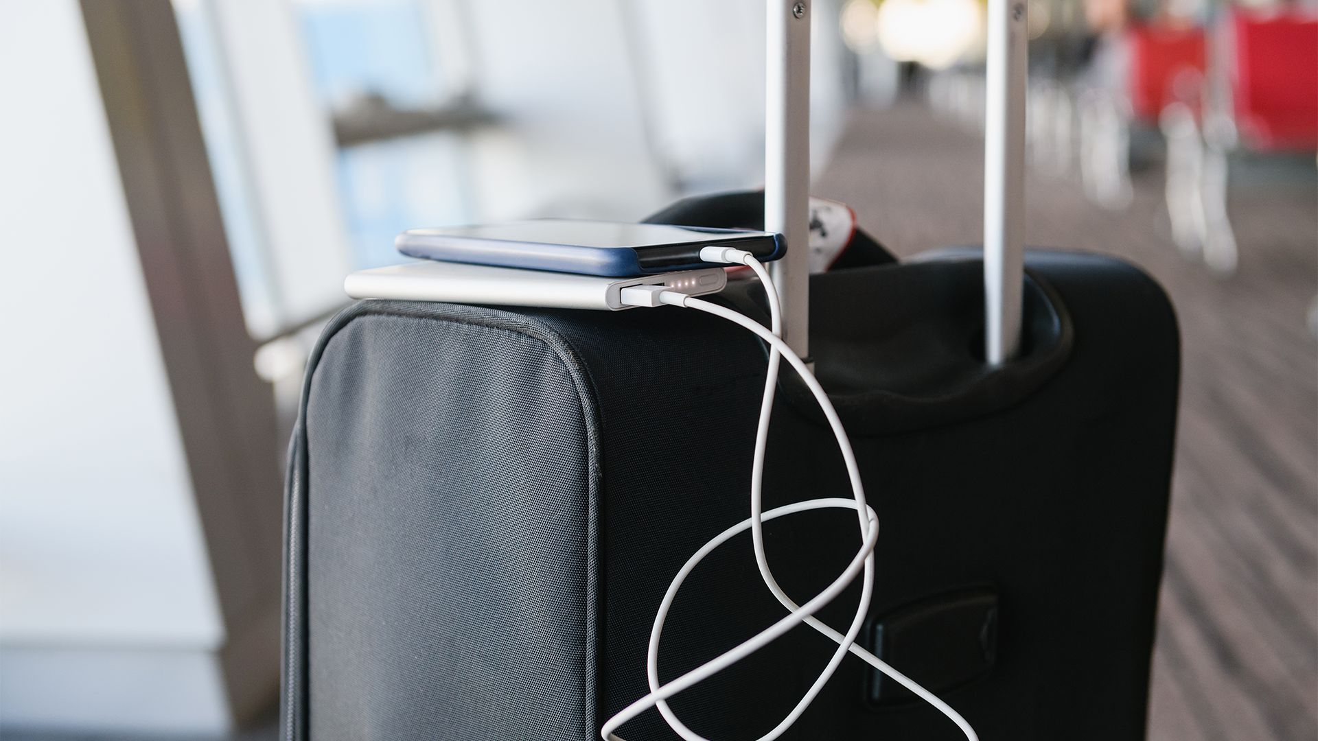 Smartphone charging from power bank on suitcase