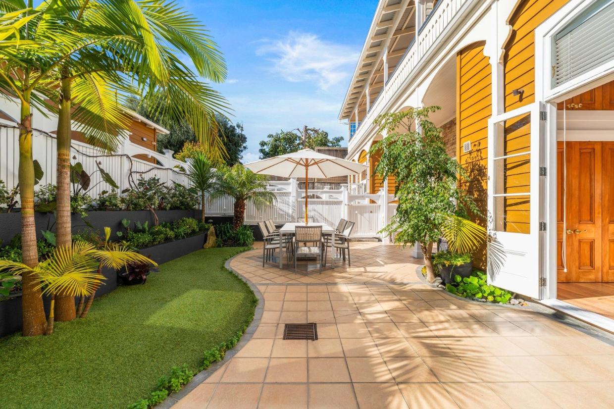 French doors open up the living area and bedrooms to a large, landscaped courtyard on the north side.