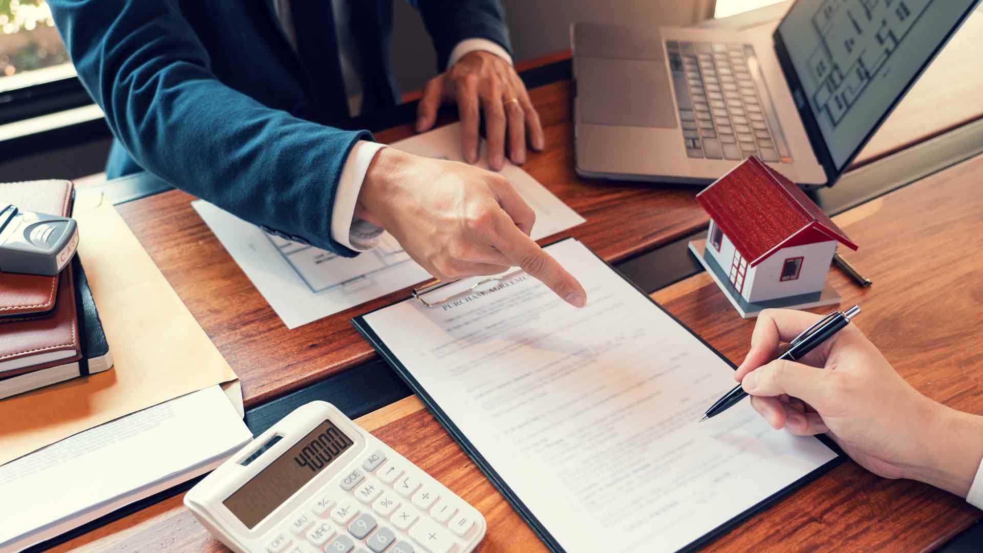 Man signing a home loan agreement.