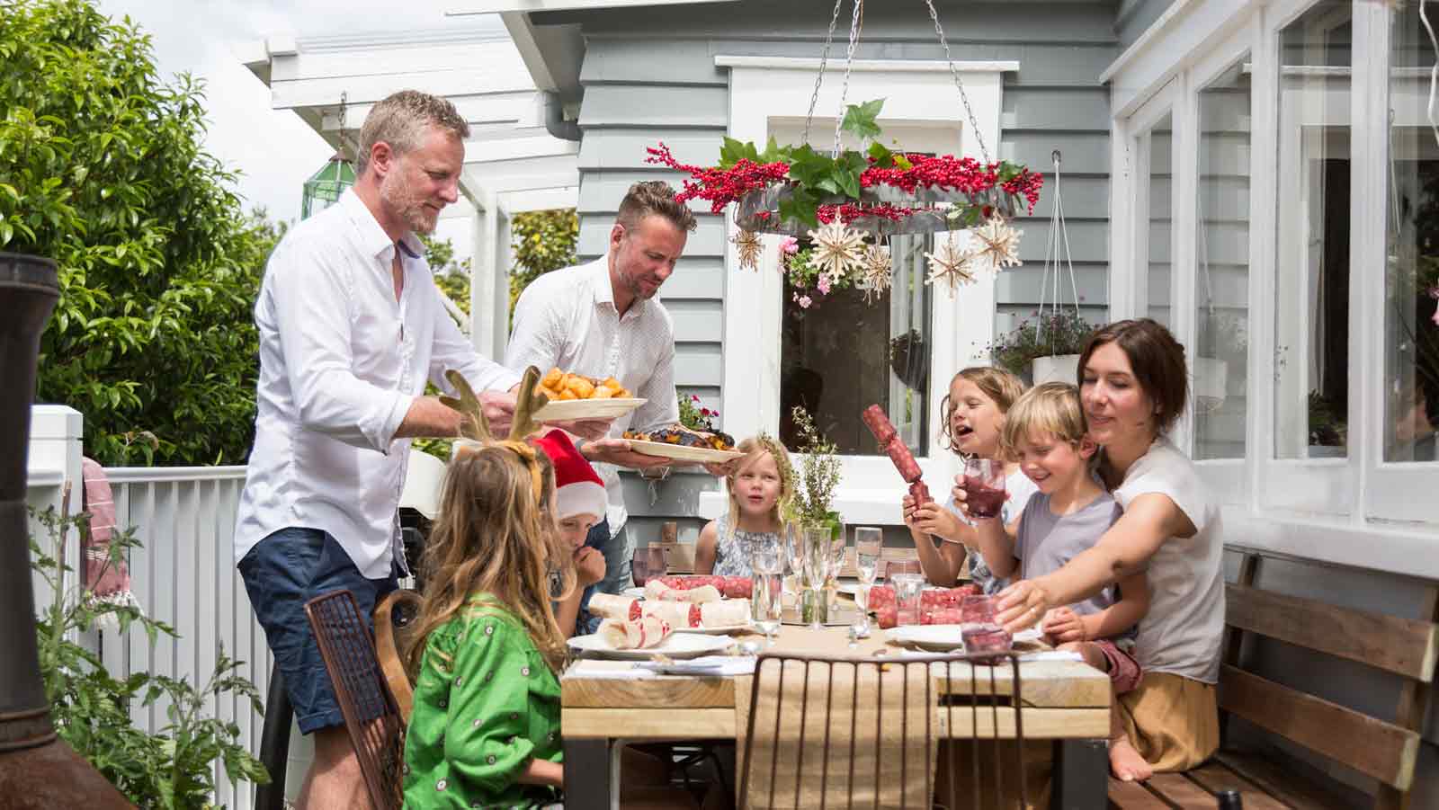 A family enjoying decorating a Christmas tree