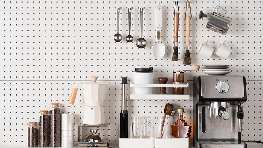 Kitchen items hung neatly on a wall in a small New Zealand kitchen.