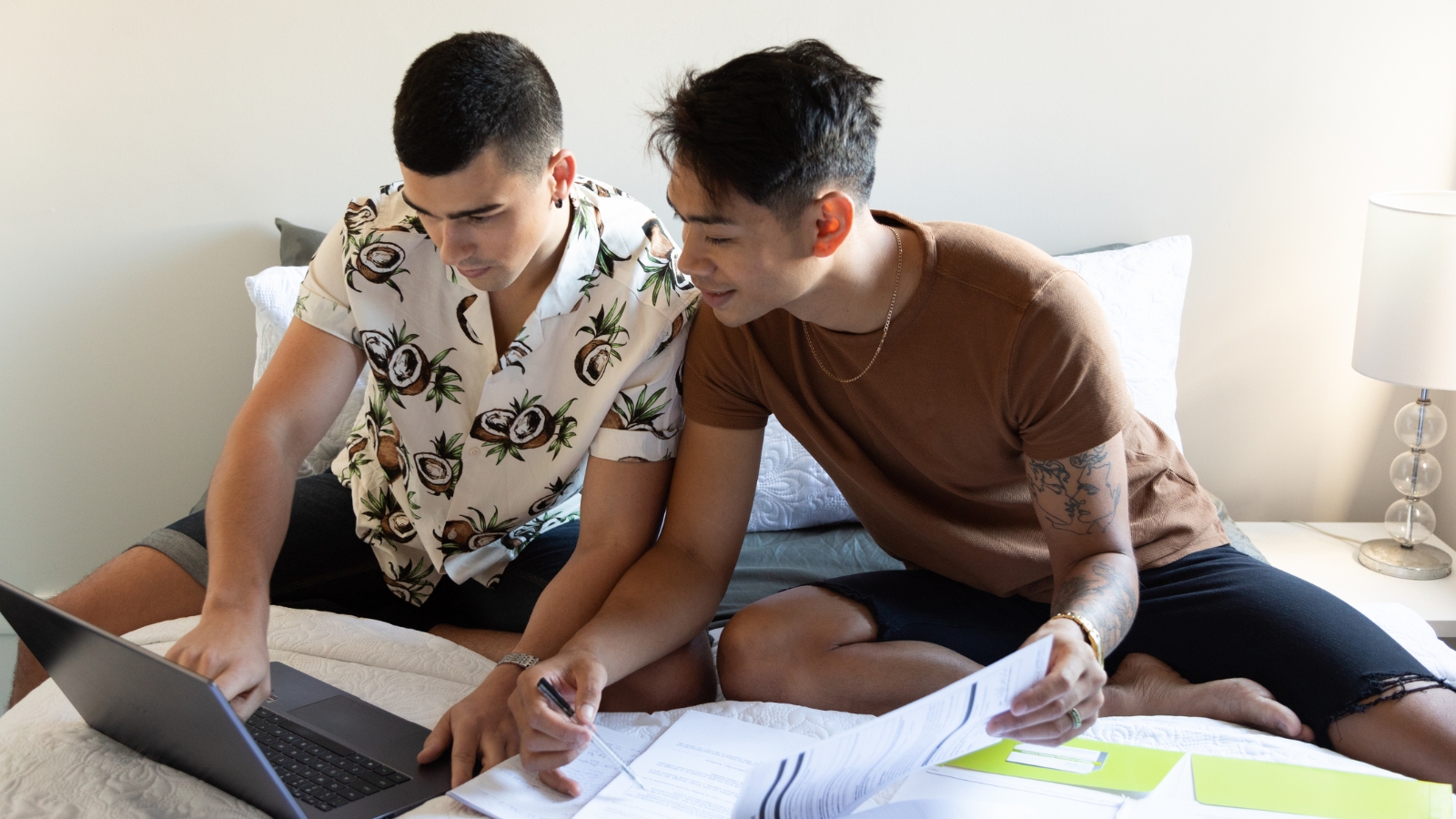 Two men looking at documents to buy a home. 