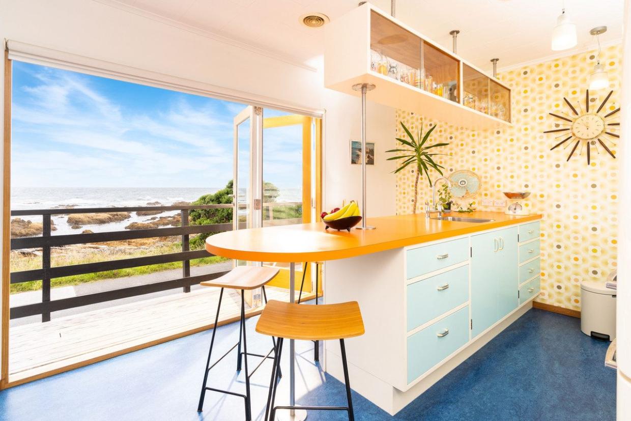 Sandy Gibbs and Chris Williams bought this seafront home in Island Bay 21 years ago and have undertaken a massive refurbishment. Both the design and materials hark back to the 1950s. Photo: Lowe & Co
