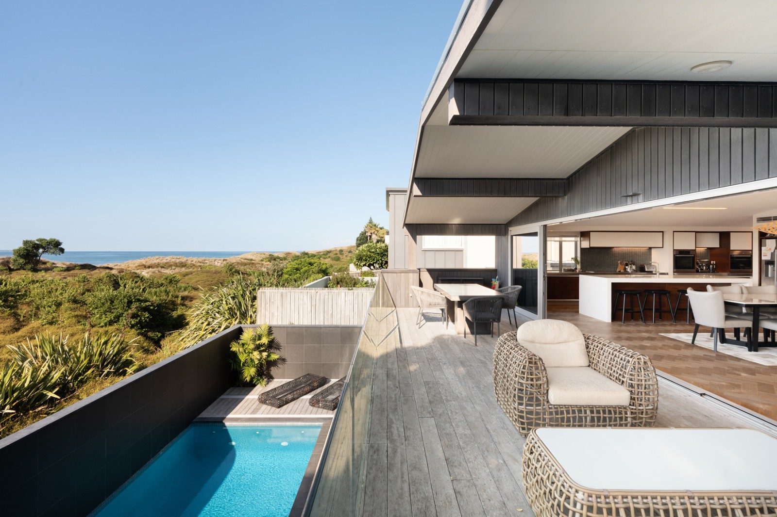 the view from the deck of the house, with the beach in the background