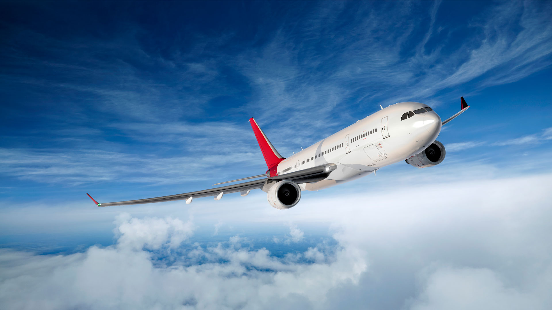 Passenger jet flying through blue skies.