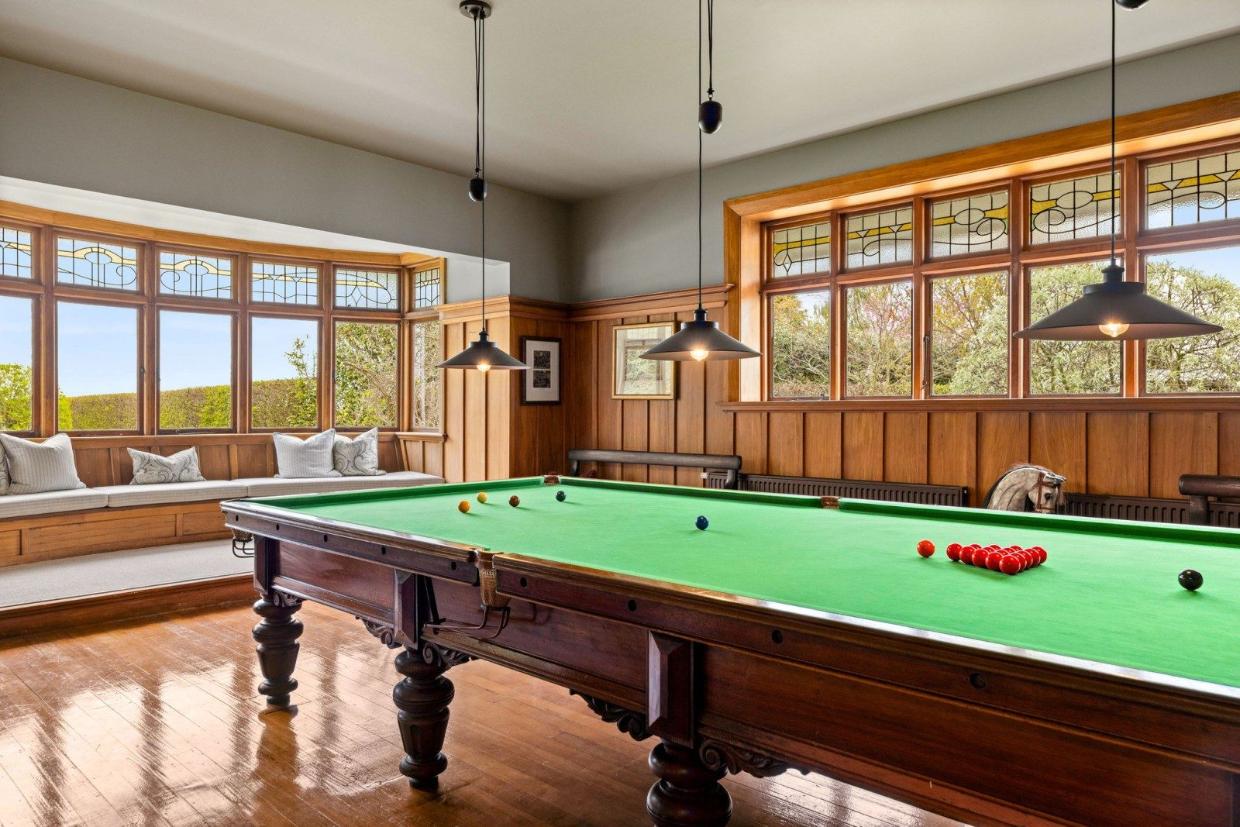Large, modern room with a billiards table.
