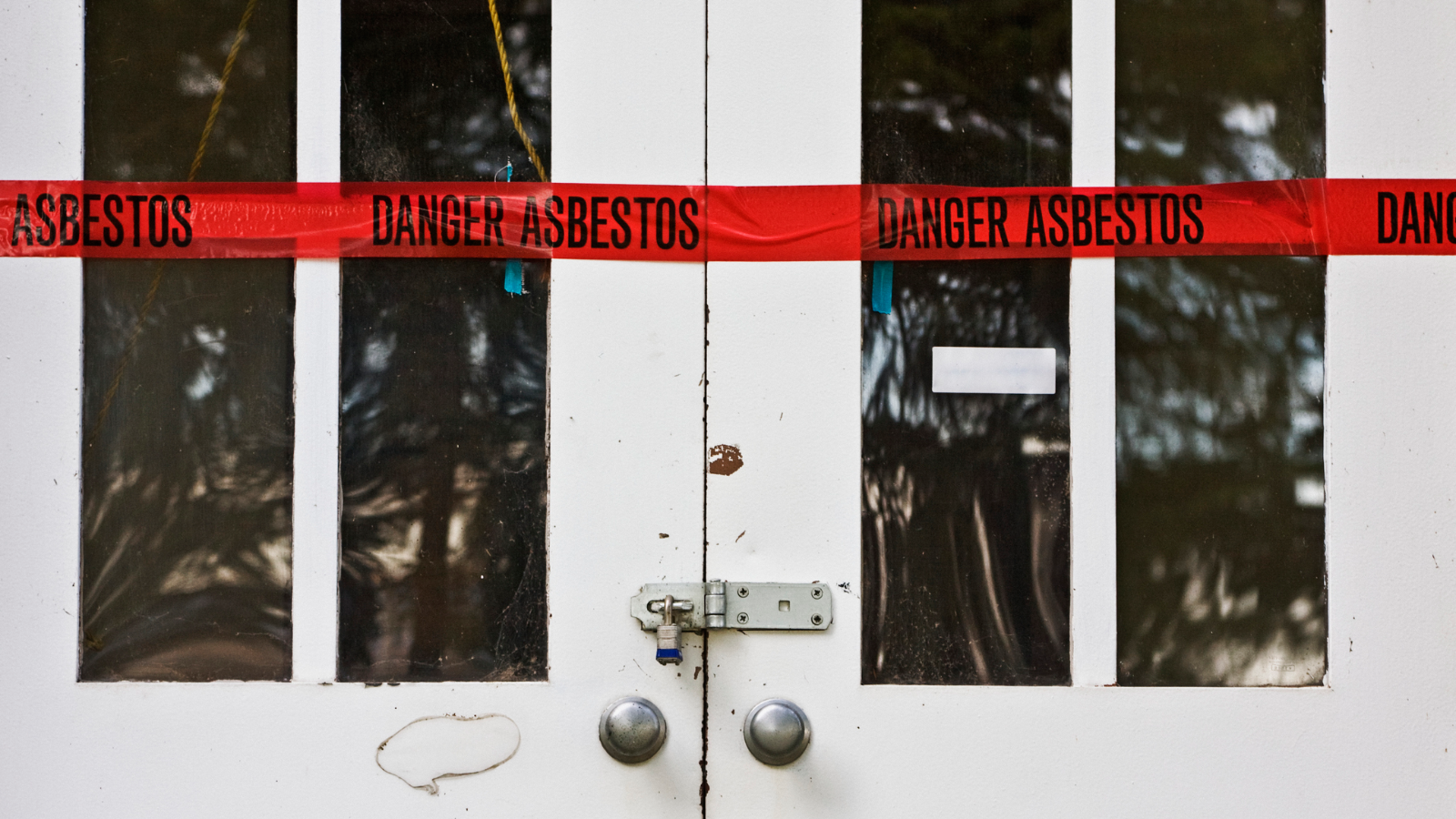 Image of doors blocked off for asbestos. 