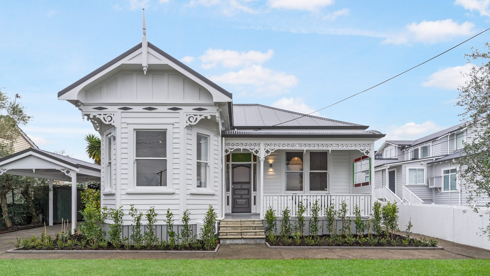 Front of white weatherboard two bedroom home