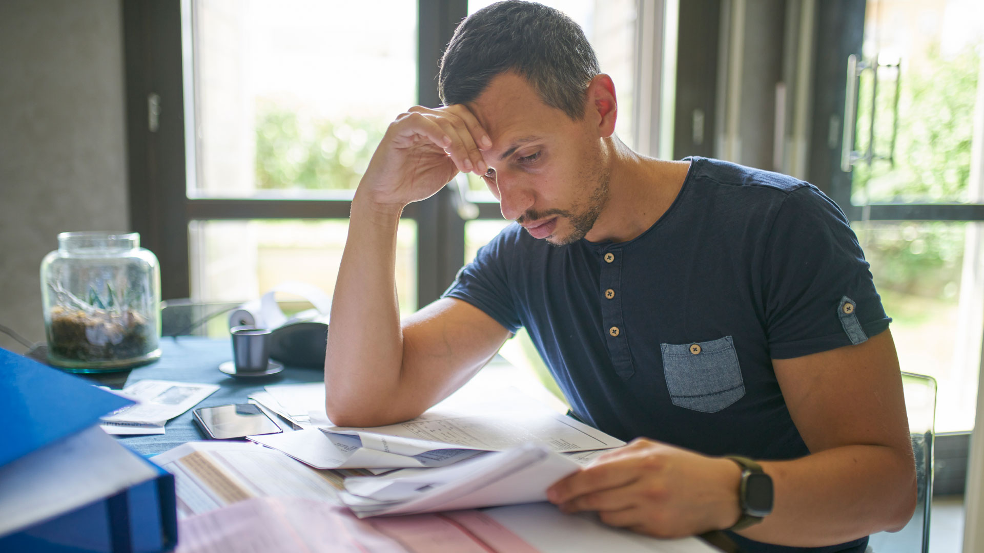 A man going through documentation to find a Code Compliance Certificates.