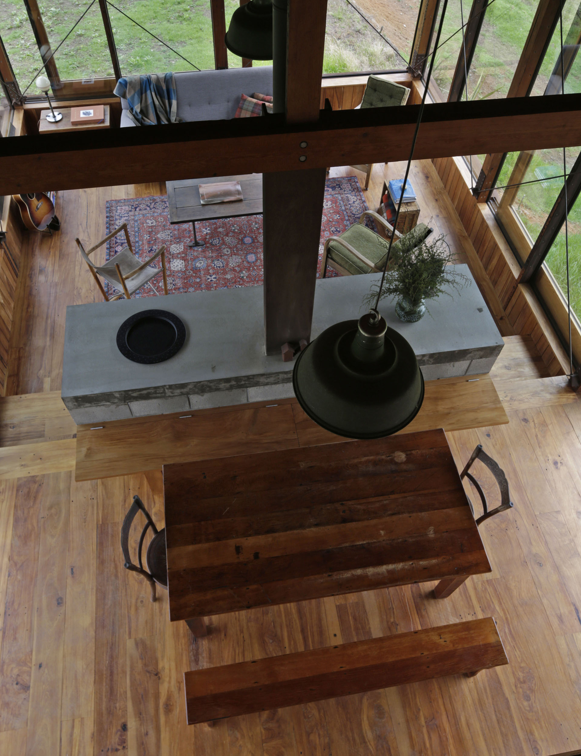 Birds-eye view of the living and dining room with rustic furniture and beautiful hardwood floors