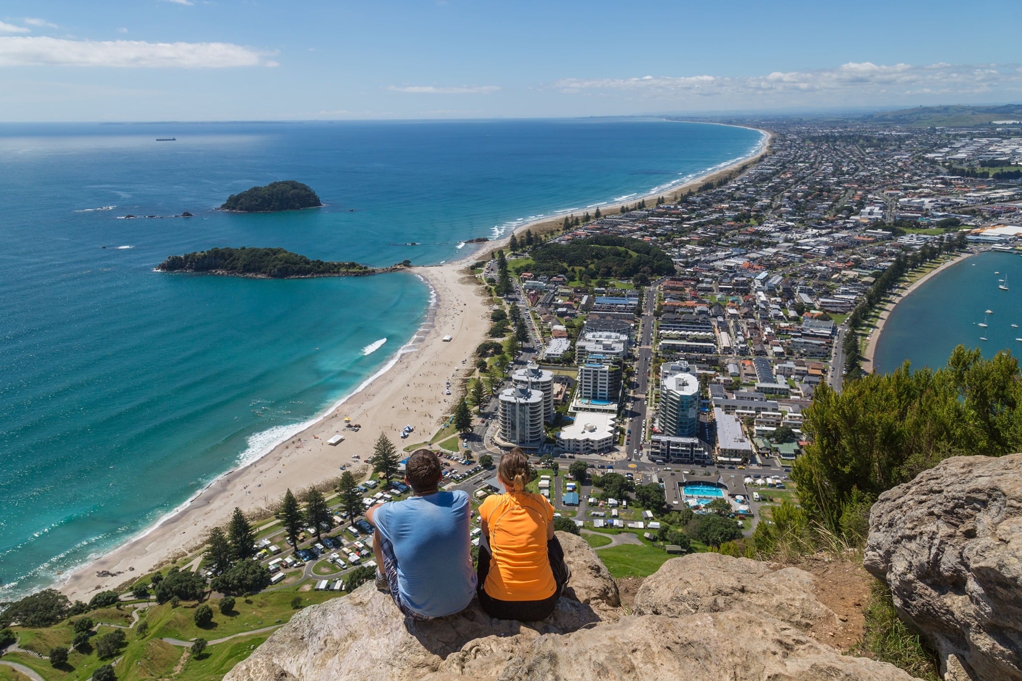 Two people up Mt Maunganui enjoying the views