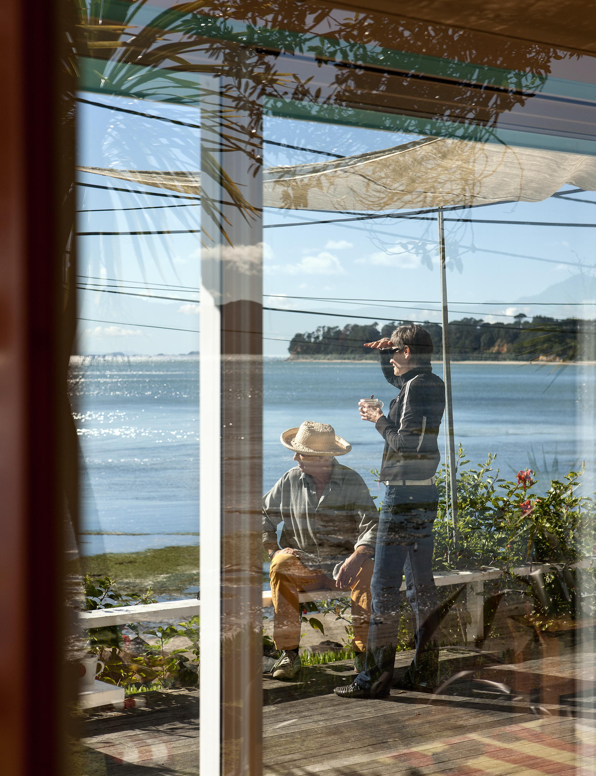 a couple looking out to sea standing on their deck