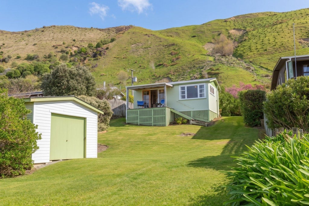 The cute two-bedroom bach in Mataikona. Photo: Property Brokers/TRADE ME