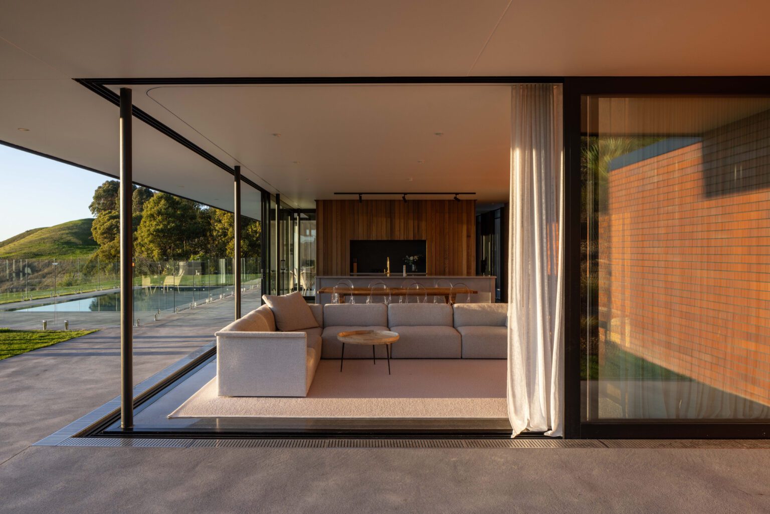 Sliding glass doors allow this open-plan living area to be almost completely open to the outdoors. Image: Hazel Redmond