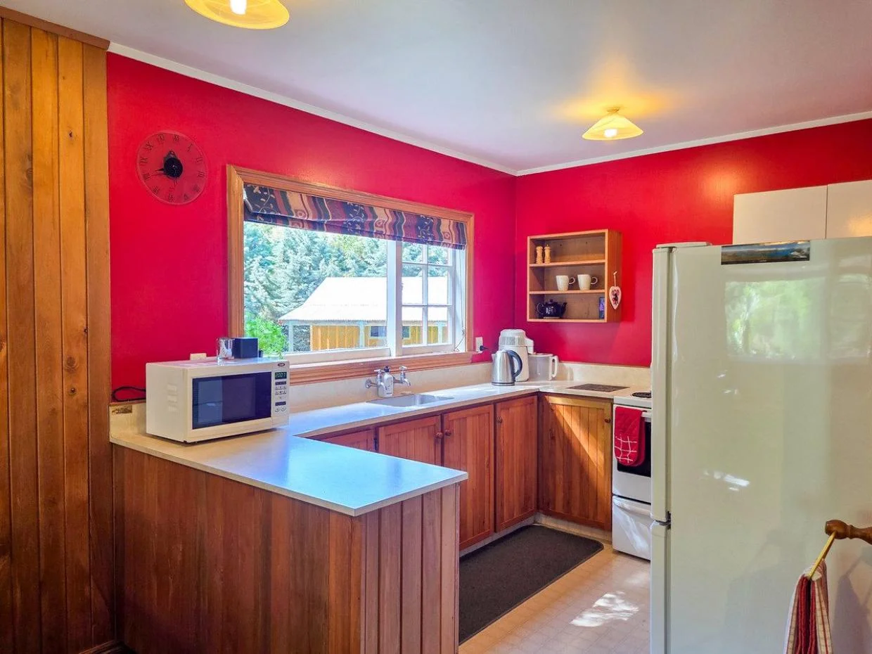 The kitchen looks out onto the countryside. 