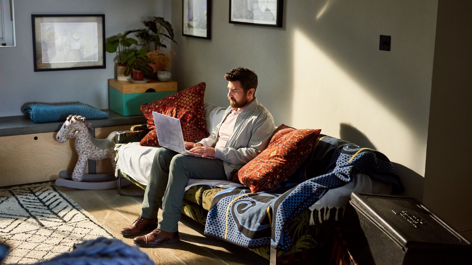 Studio apartment Auckland guy on laptop. 