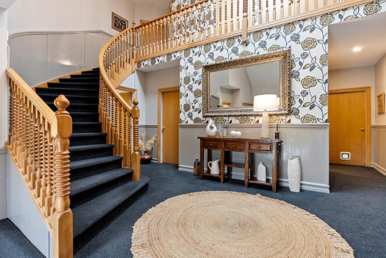 The sweeping staircase at the property