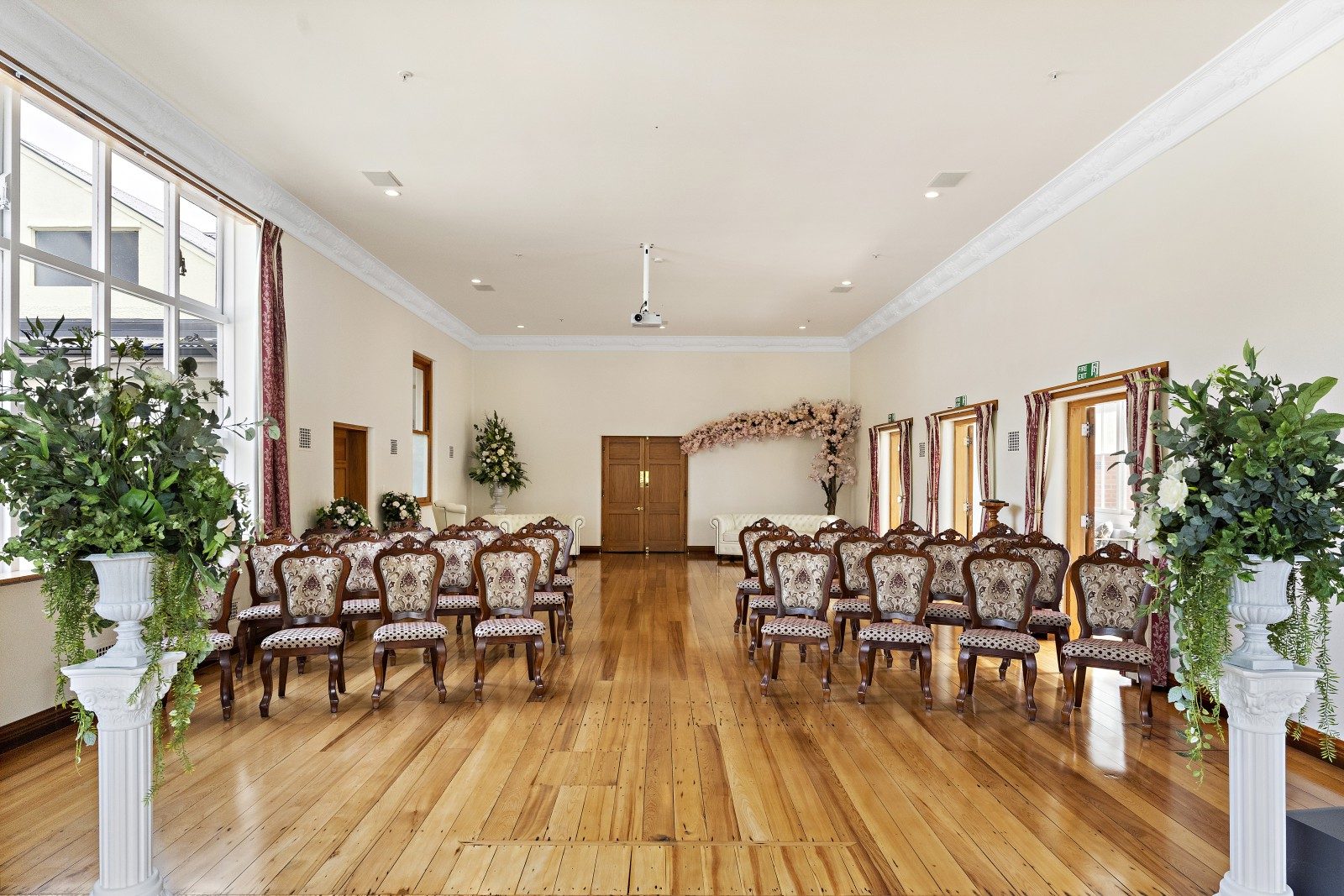 Ballroom at the property set up for a wedding with beautiful antique chairs
