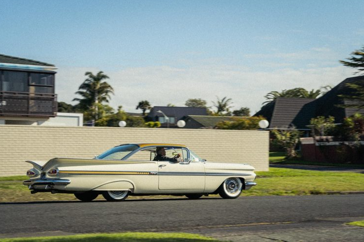 1959 Chevrolet Sport Coupe side view driving