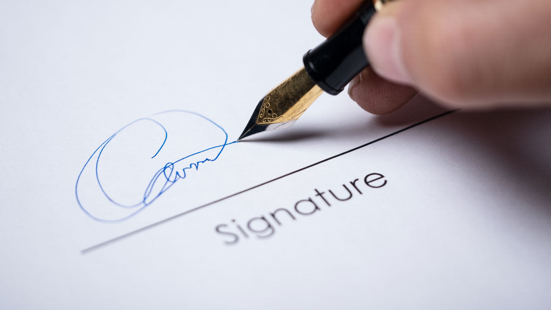 Person signing a job contract.