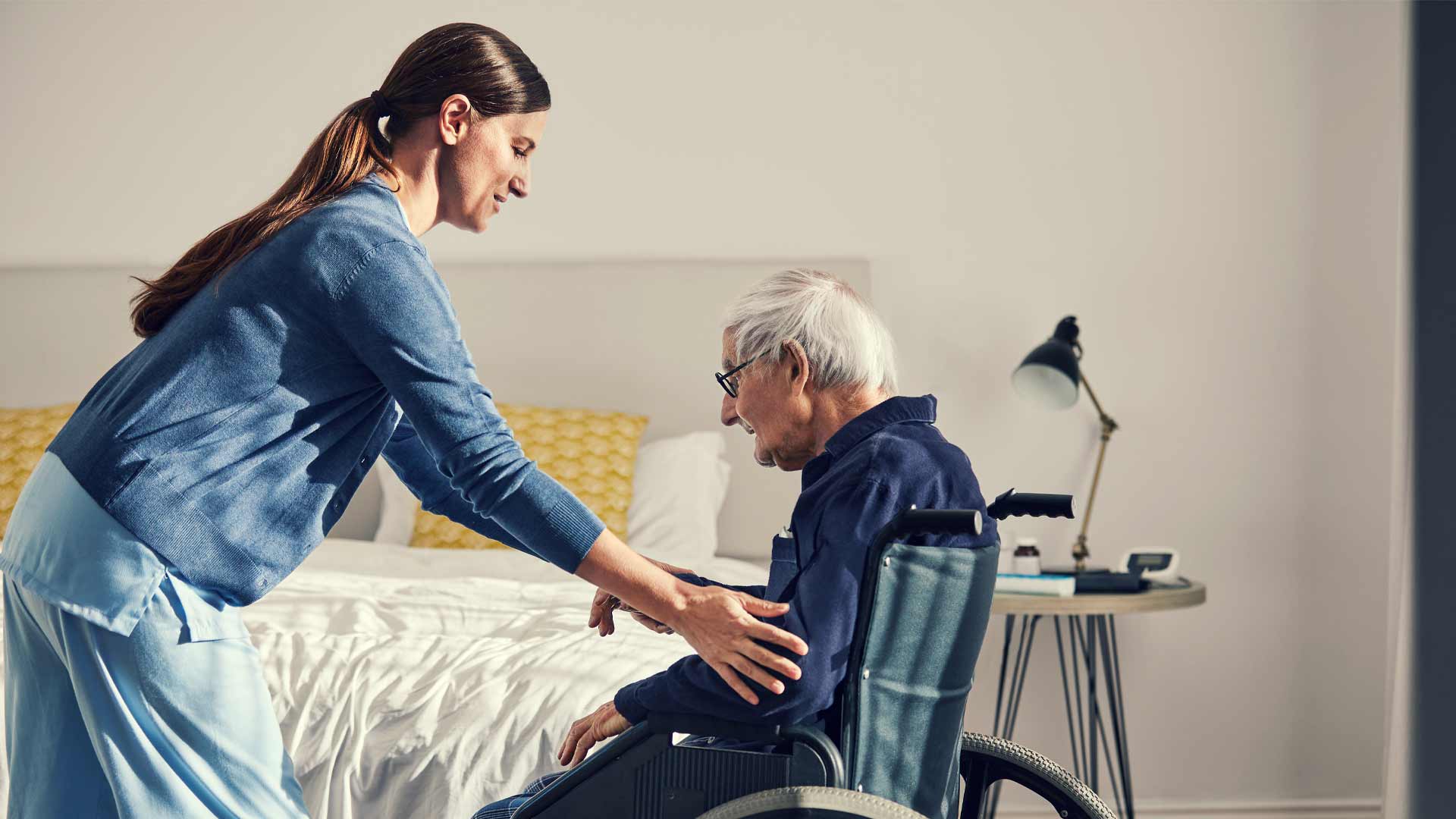 Healthcare assistant working with an elderly patient in New Zealand.