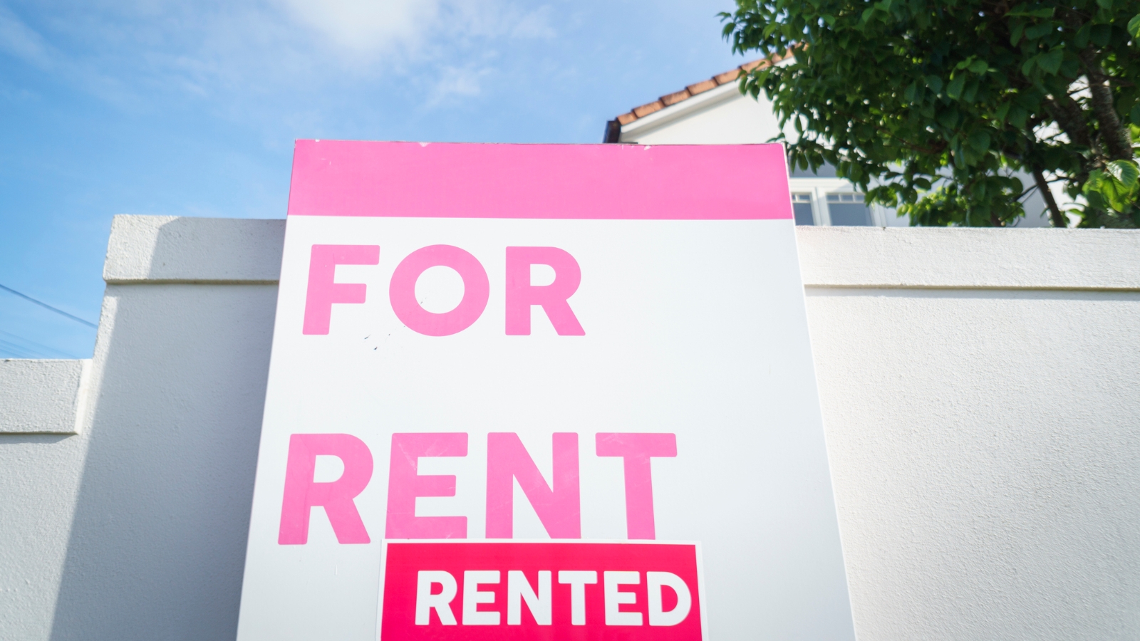 For rent sign in front of house. 