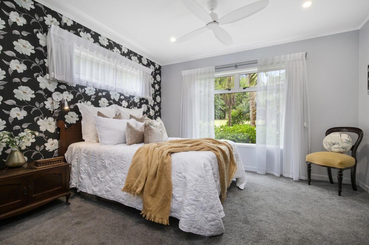 Inside, the home has three double bedrooms, including this master suite.