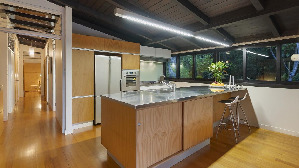 The kitchen has timber cabinetry - the contrast between light and dark timbers is another typical Modernism feature. Photo: NZ Sotheby's