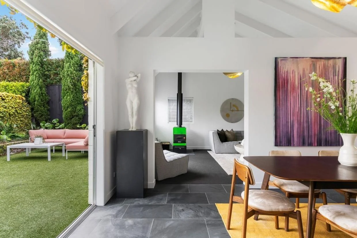 The dining area opens onto a courtyard style garden, and through to the living room.
