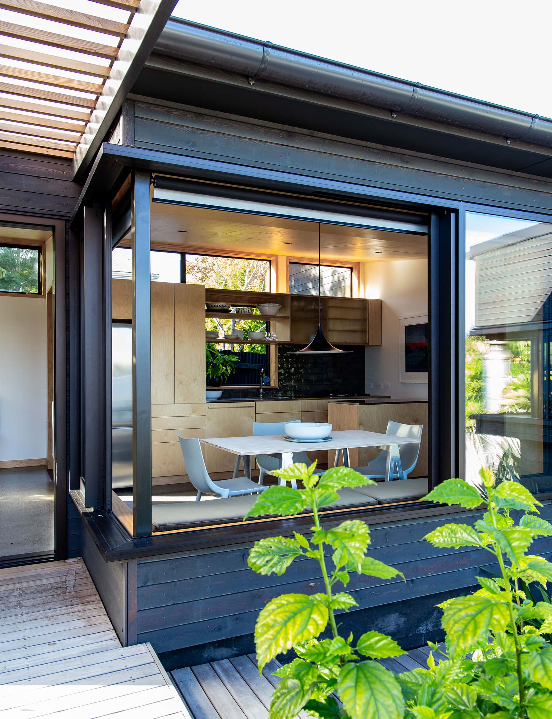 View into the kitchen and dining room through full length open windows