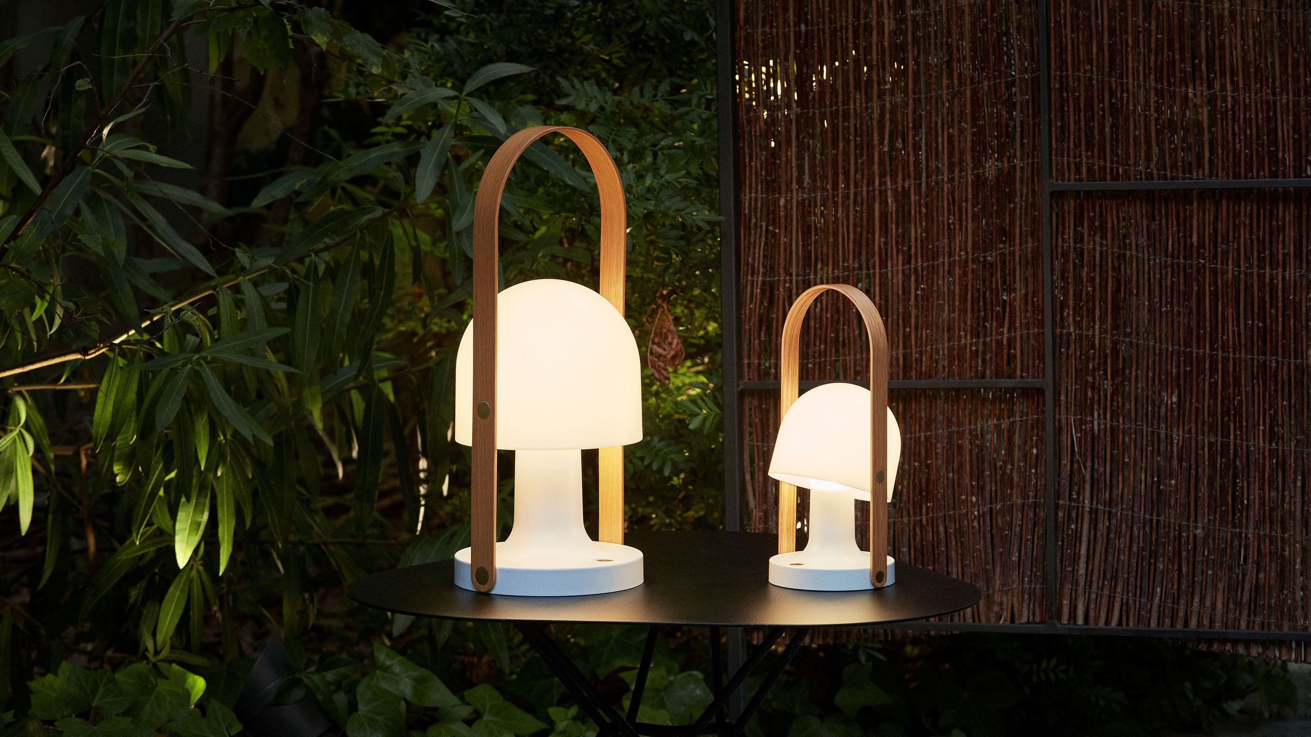 Two table lights, lit up in the dark