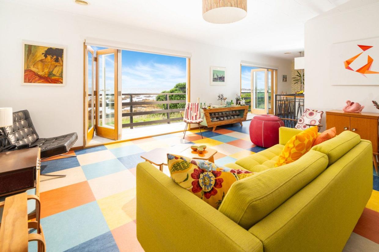 Marmoleum tiles feature on the flooring in the living area, reproducing colours in the furnishings and kitchen. Photo: Lowe & Co