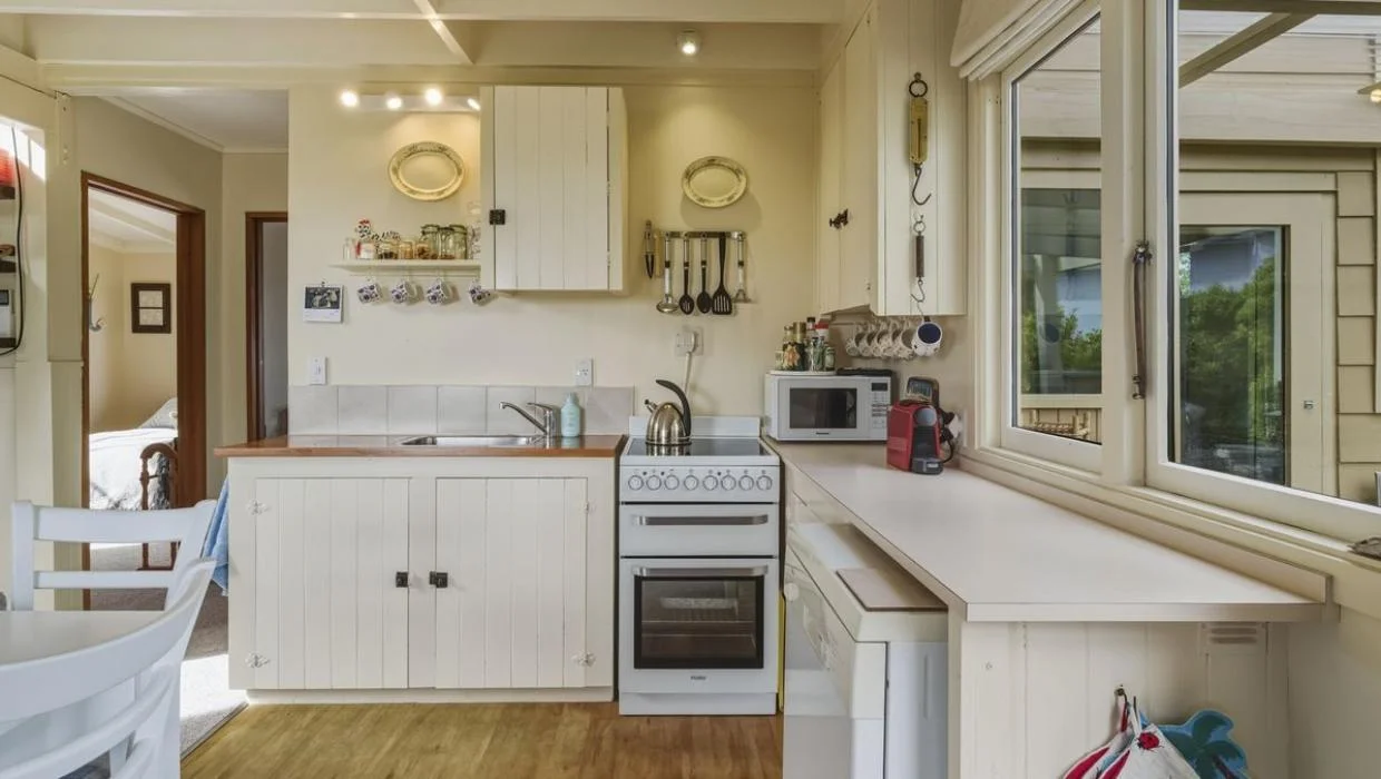 Painted boards form the cabinet doors in the kitchen that’s perfectly in keeping with tradition.