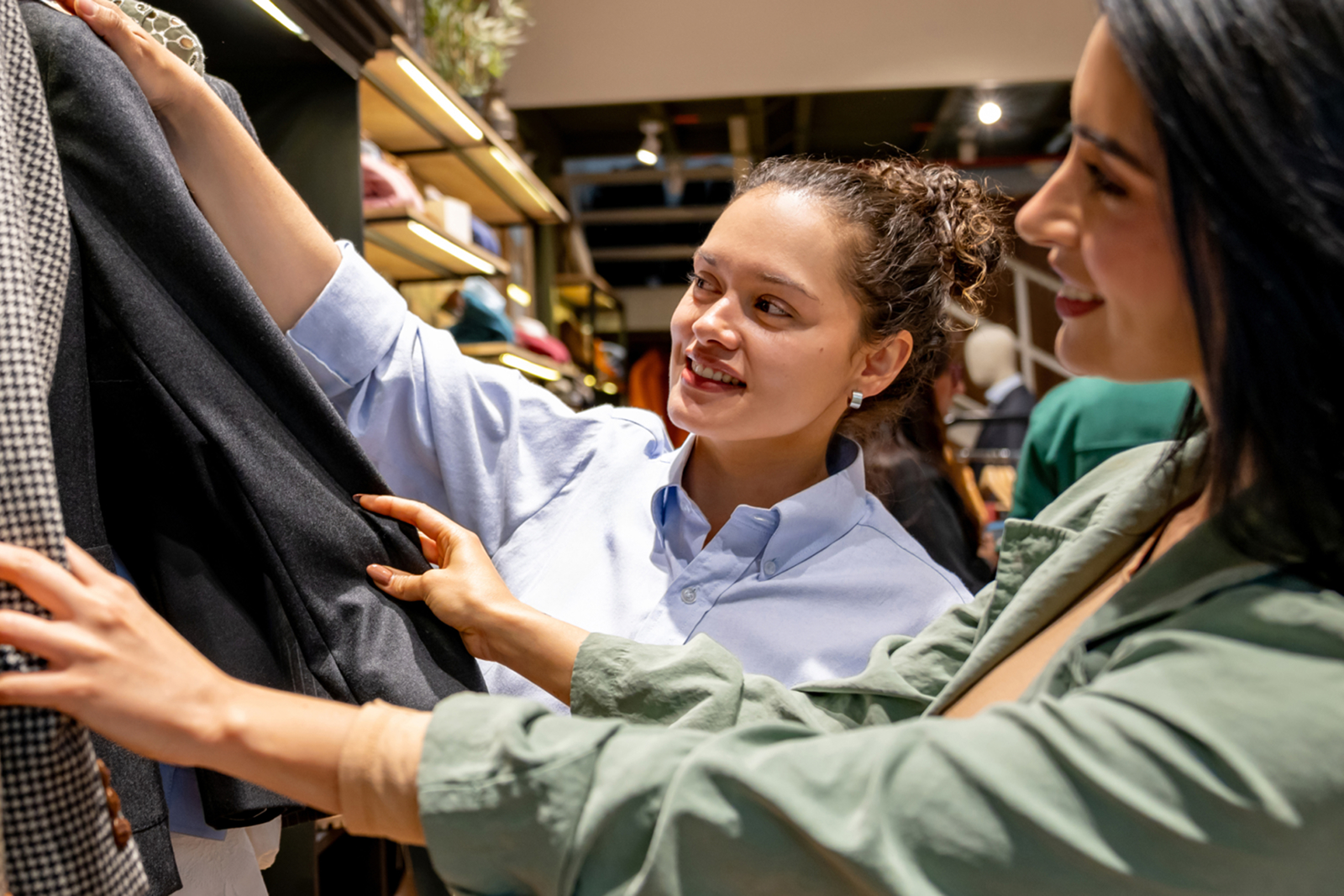 Young retail worker helping a customer.