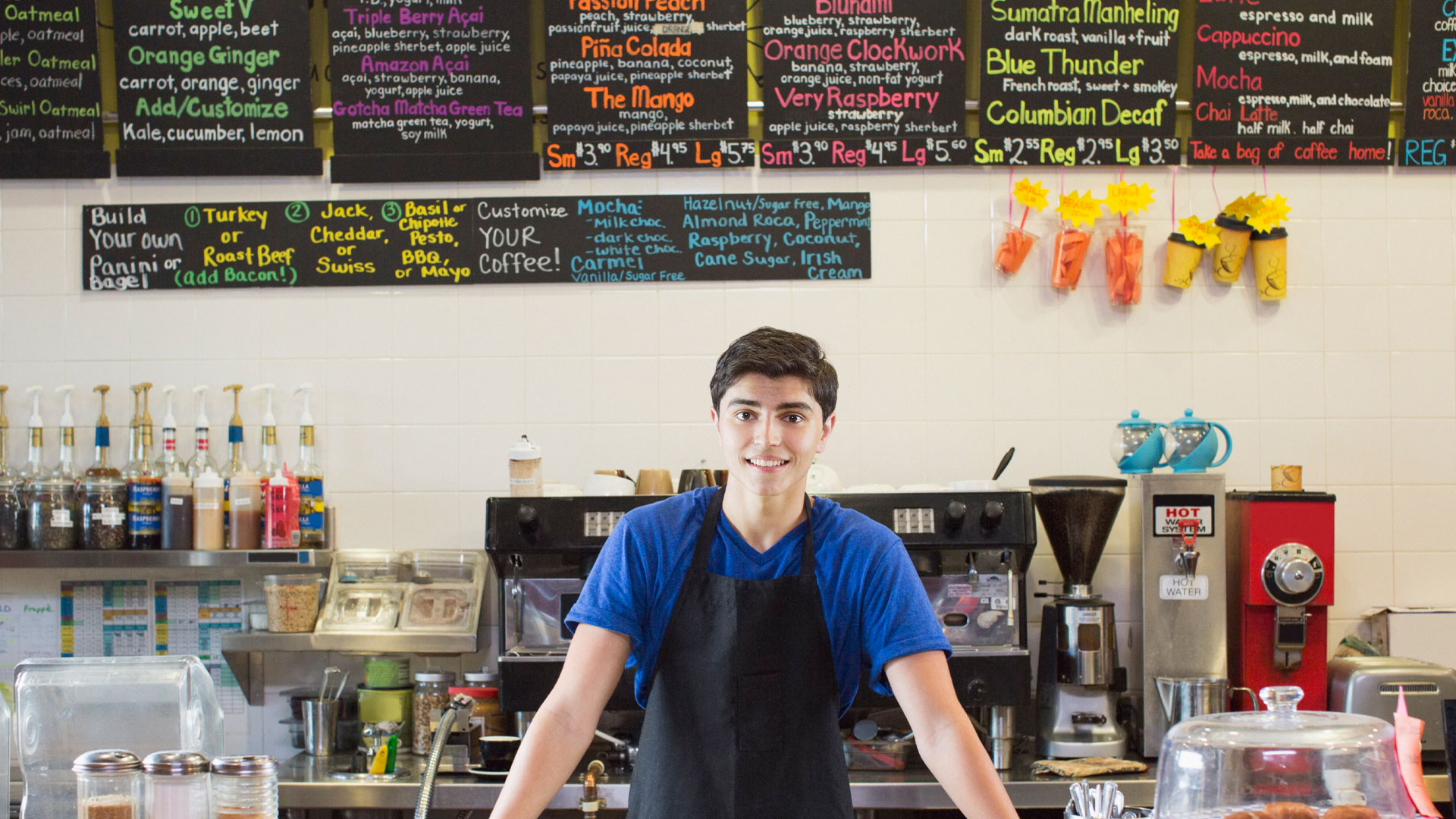 Young man standing at a cafe counter