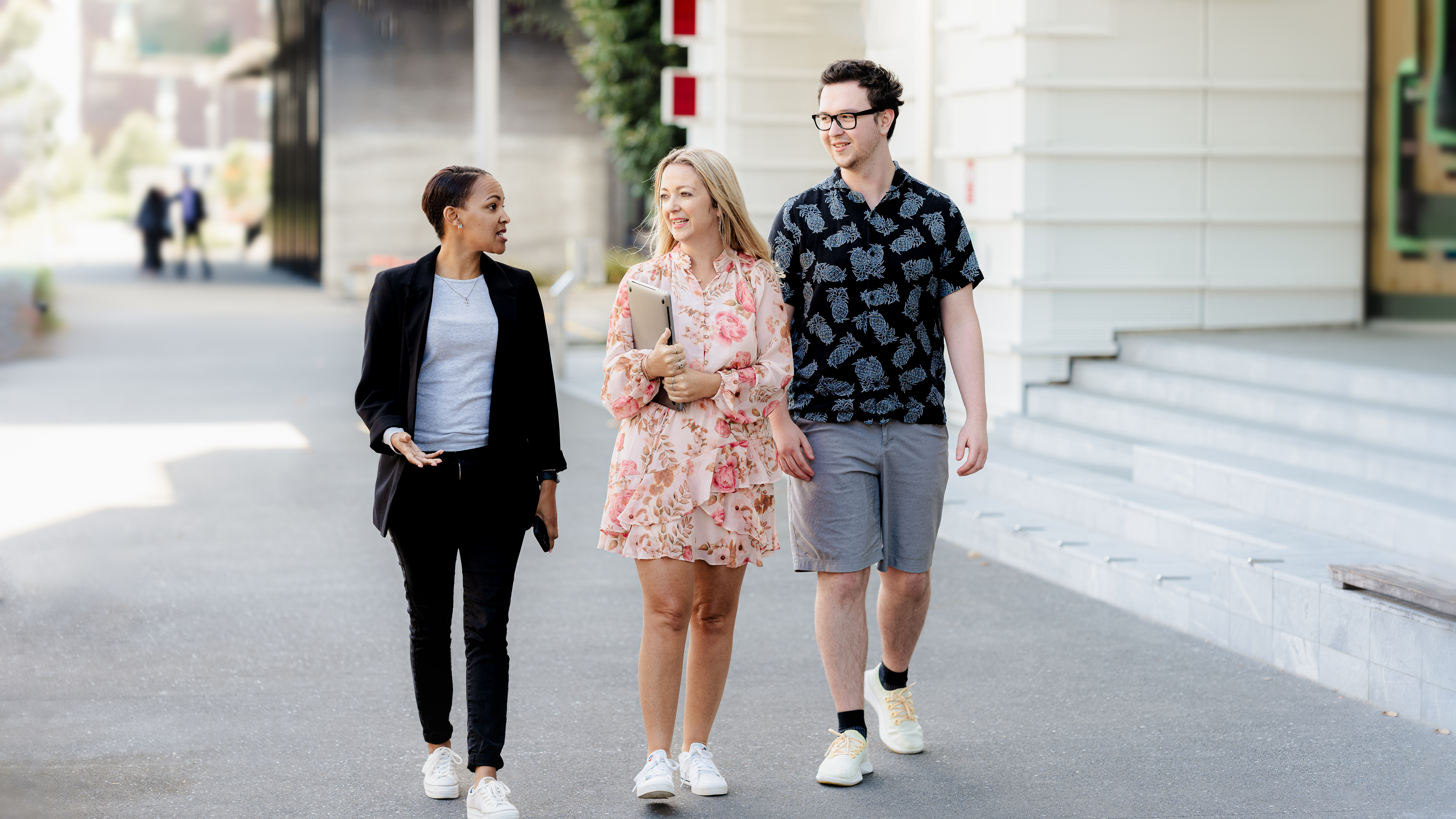 a team of three walking on a footpath