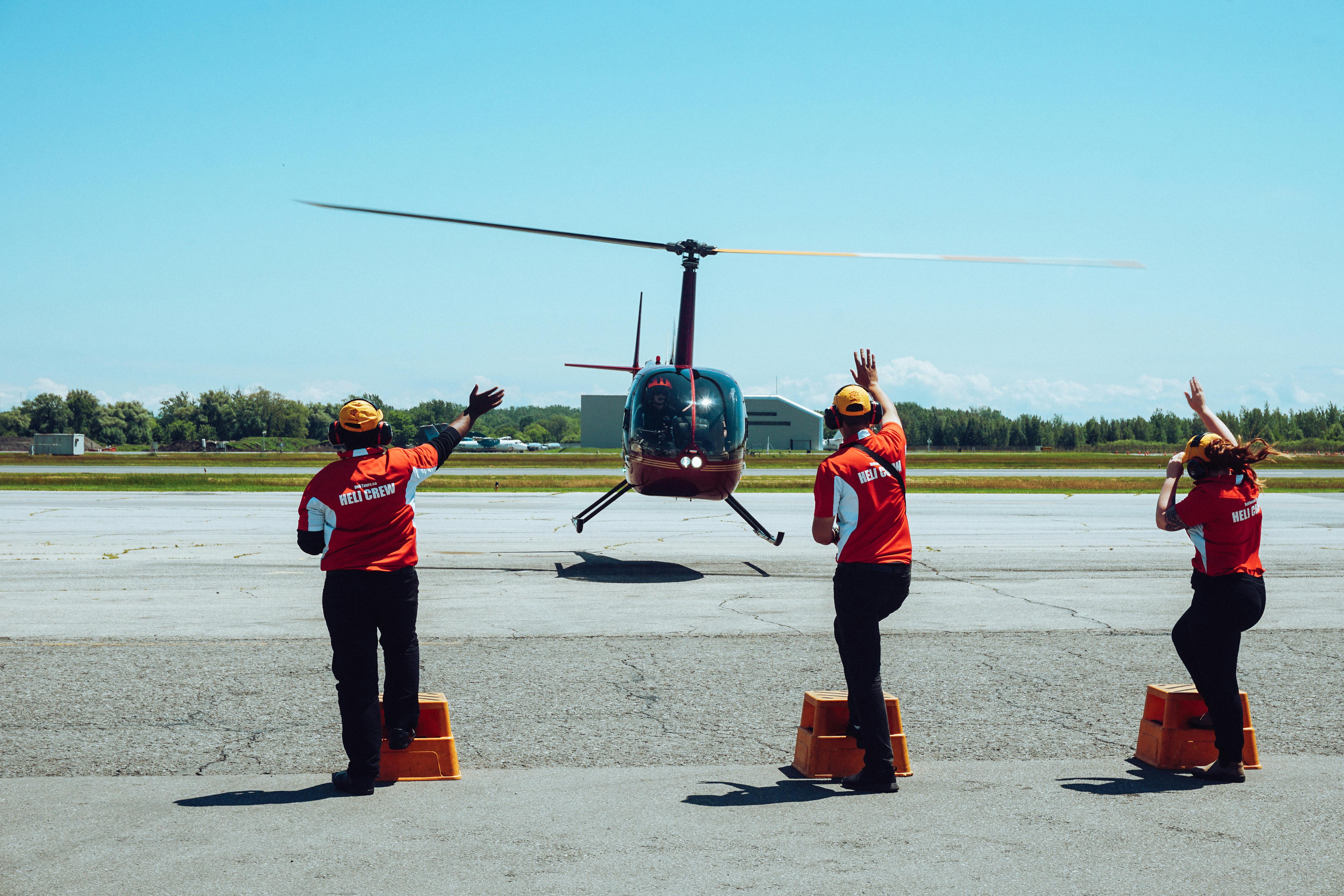 Helicopter grounds team helping helicopter come into land