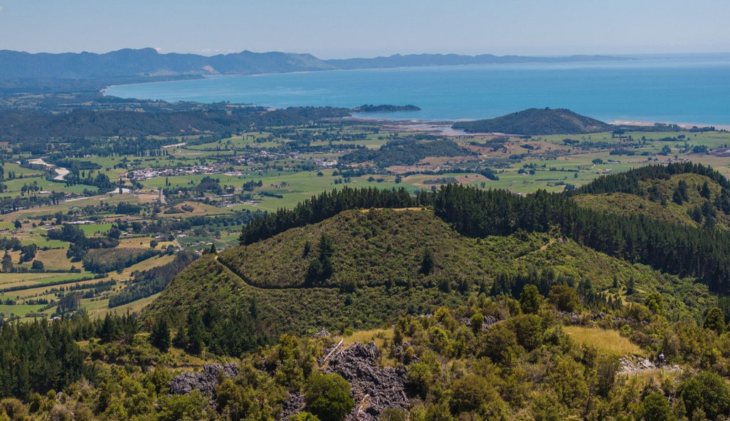 A view from a hilltop looking out to sea from a offgrid property for sale in Golden Bay.