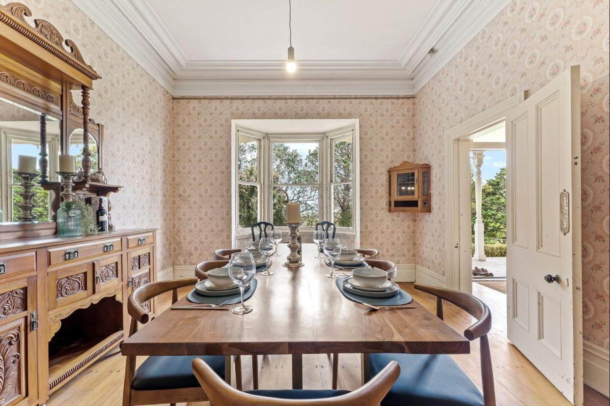 The formal dining room has a bay window, and a door onto the veranda. 