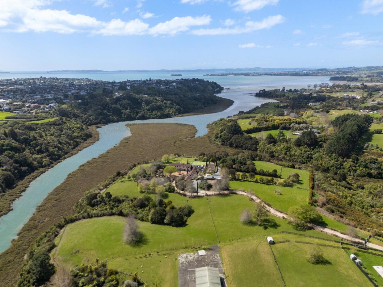 View of paddocks and a lake. 