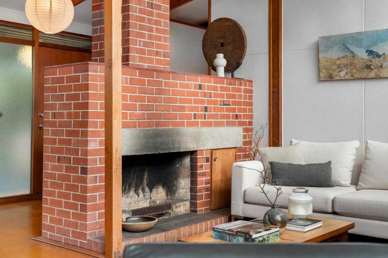 Exposed brick fireplace in the living room