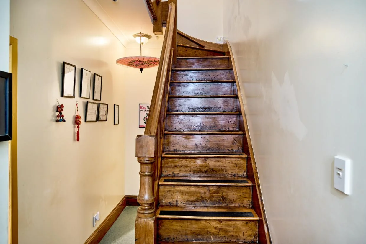 The original hand-carved staircase remains.