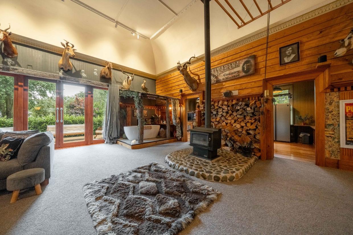 There is a bath in the living room of the transformed home. 