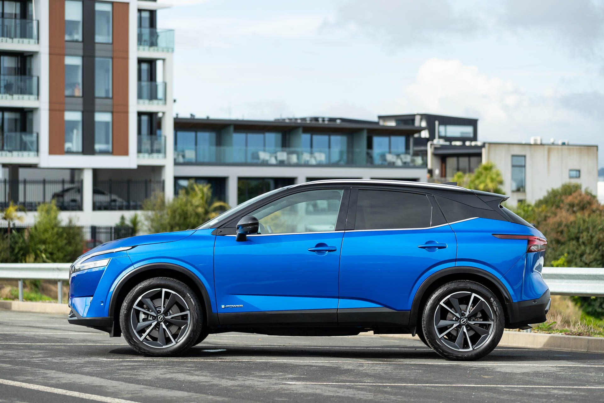 Blue Nissan Qashqai E Power stationary shot from side view