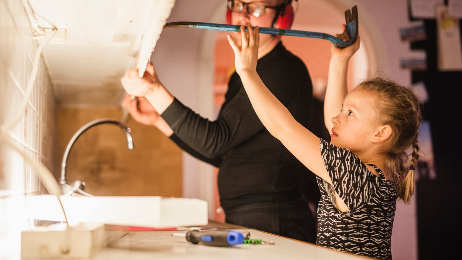 Man and his daughter renovating kitchen. 