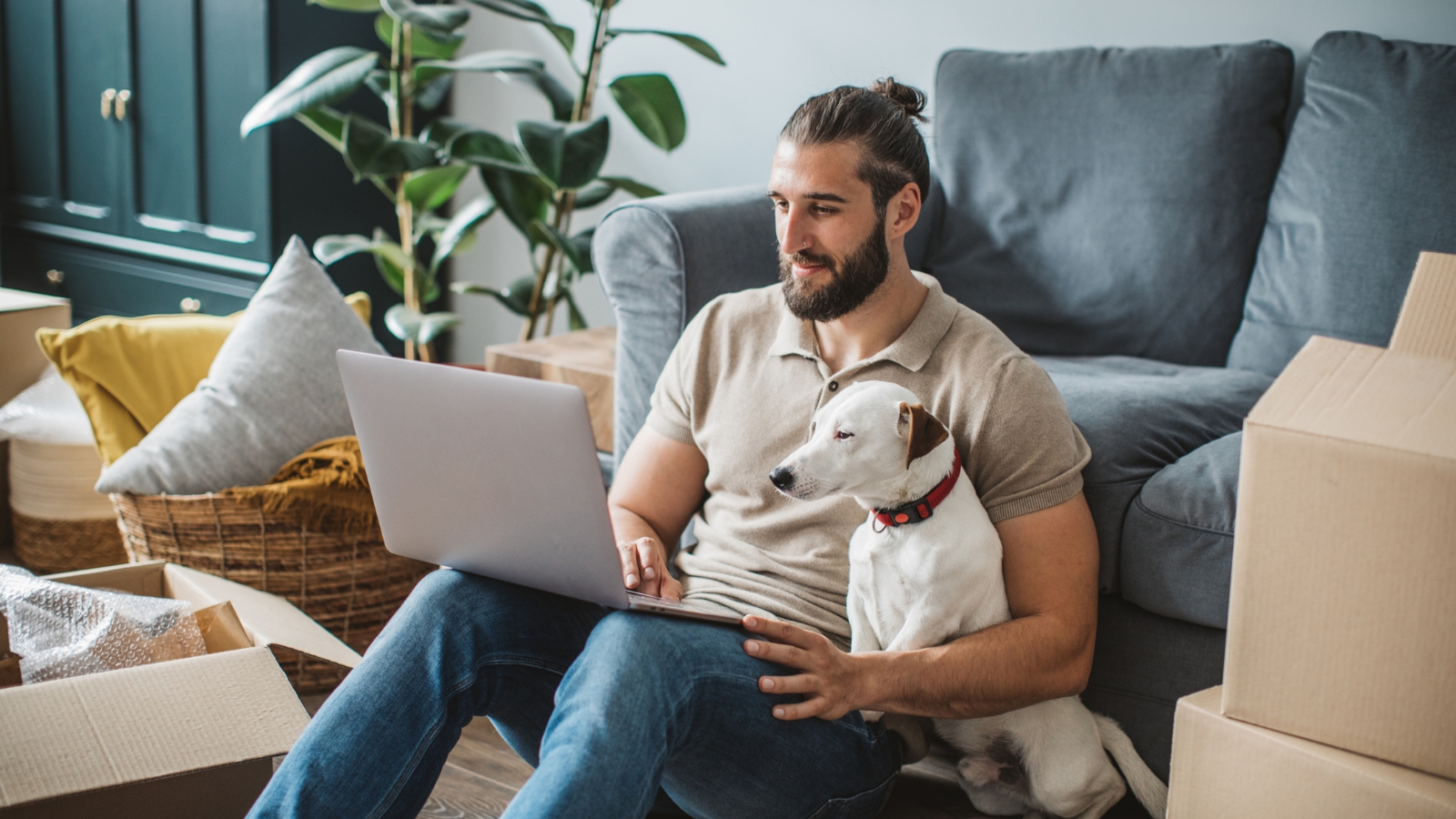 Guy on laptop with dog. 