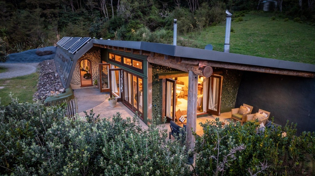 The house hunkers down into the landscape - the rear wall of earth-filled tyres acts as a double insulator. Photo: Pete May