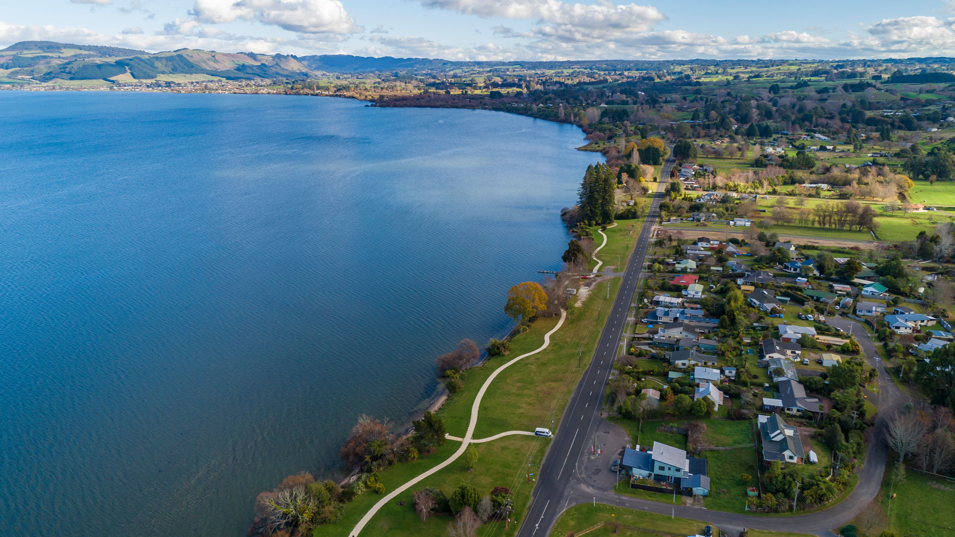 A photo of Lake Rotorua, with the town in the background.